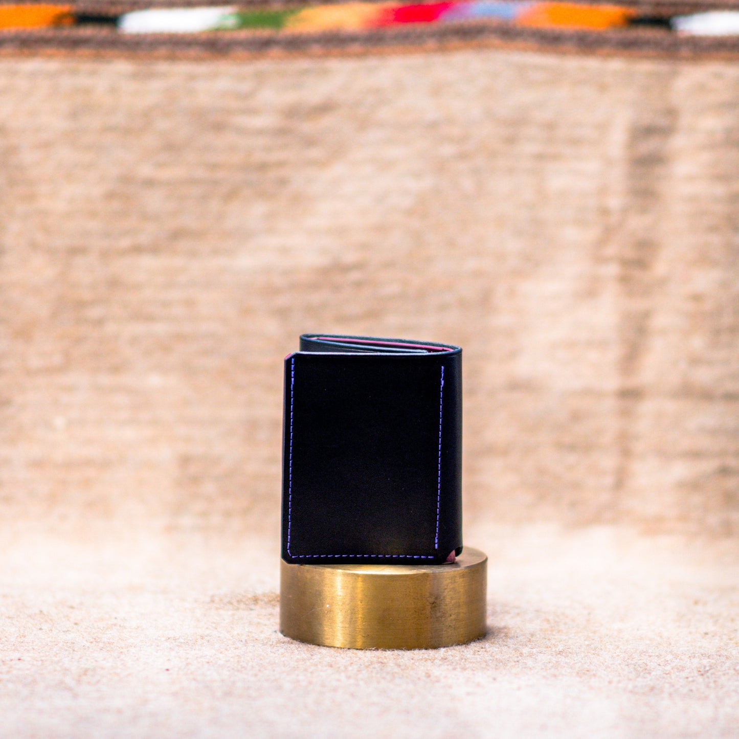 Blue wallet on a gold stand with a blurred background
