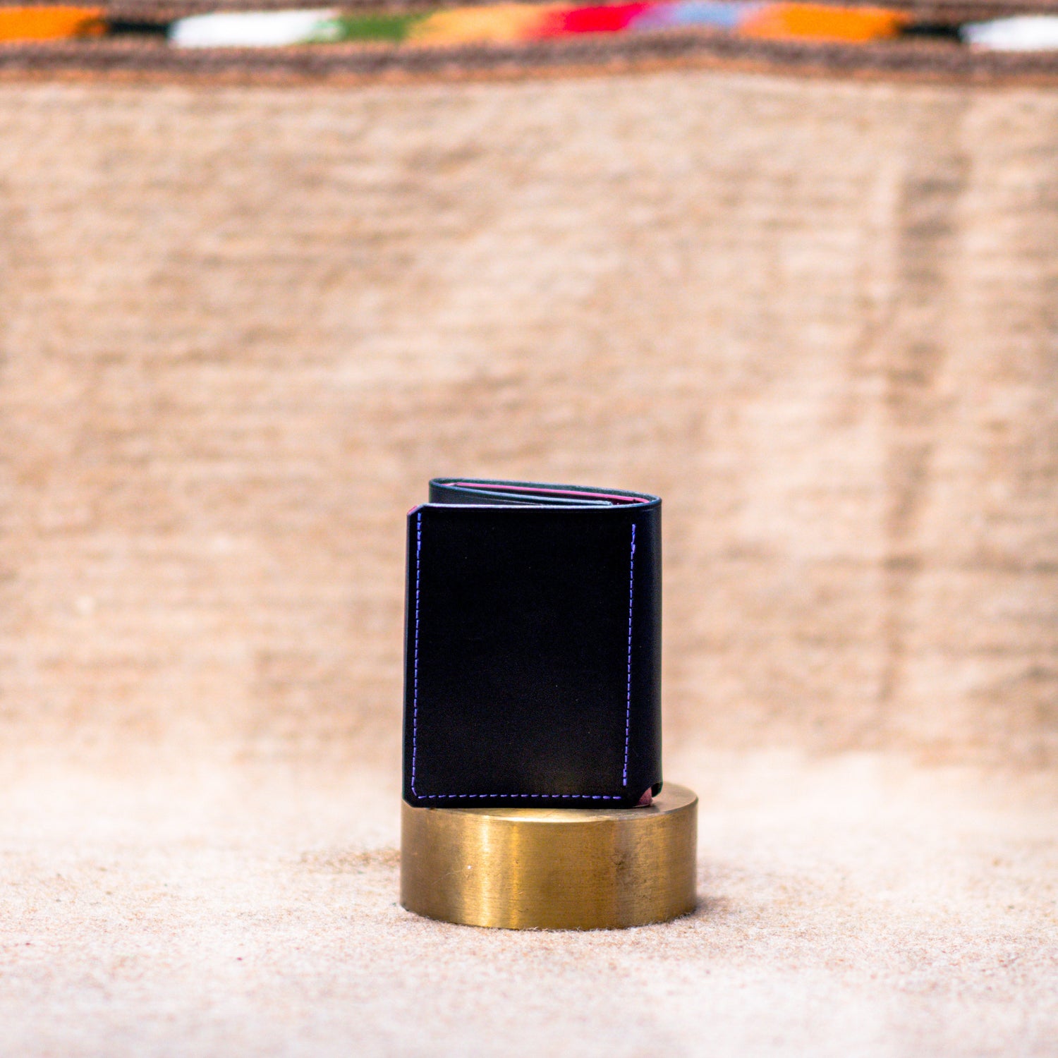 Blue wallet on a gold stand with a blurred background